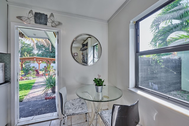 dining area featuring crown molding and tile patterned floors