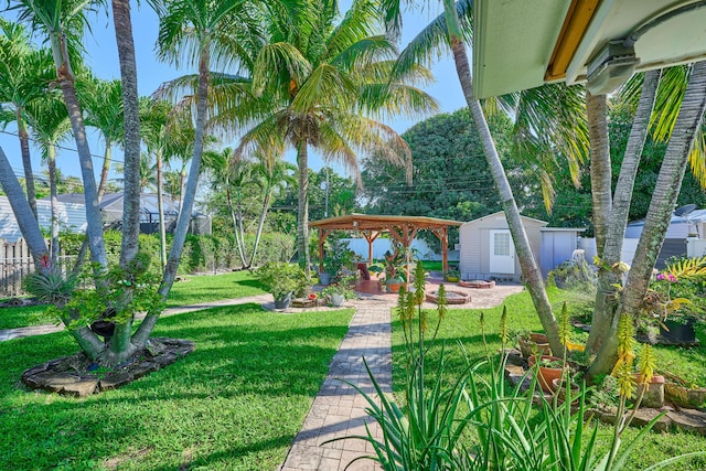 view of yard with a gazebo, fence, an outdoor structure, and a patio