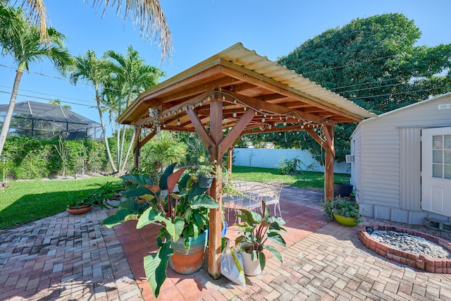 view of patio / terrace featuring a gazebo, an outbuilding, and fence