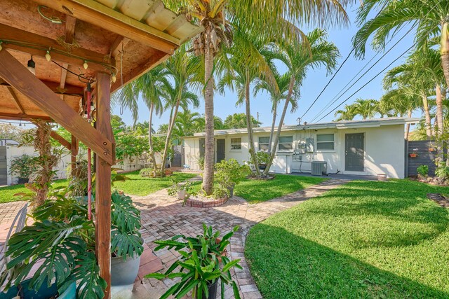 view of yard with cooling unit, a patio area, and fence