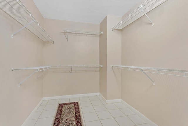 spacious closet with light tile patterned flooring