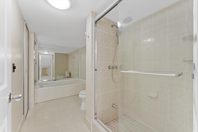 bathroom featuring tile patterned floors, toilet, and a shower stall