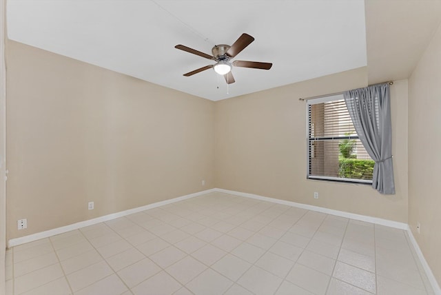 unfurnished room with baseboards, light tile patterned flooring, and a ceiling fan