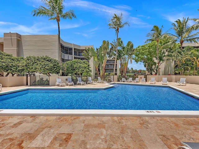 community pool featuring a patio area and fence