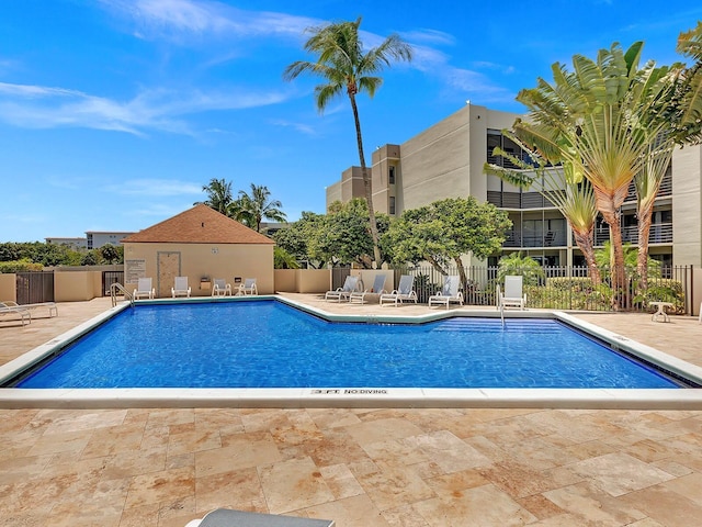 pool featuring a patio area and fence