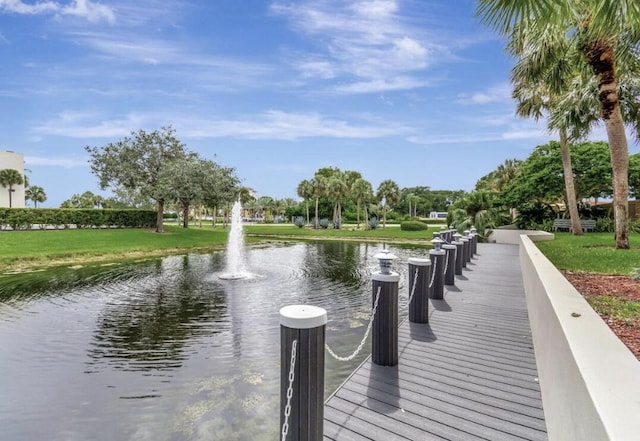 5651 Camino Del Sol Unit 103, Boca Raton, FL 33433 - dock with a water view and a lawn