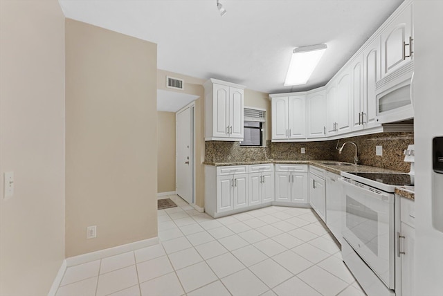 kitchen featuring a sink, tasteful backsplash, white appliances, white cabinets, and light tile patterned floors