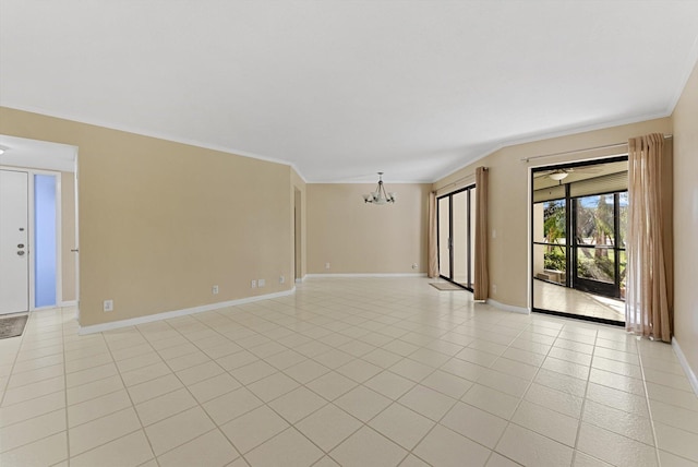 empty room featuring light tile patterned floors, a notable chandelier, baseboards, and ornamental molding