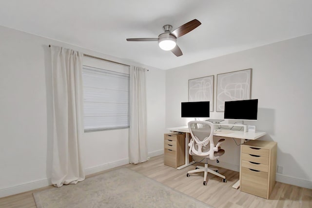 office with baseboards, light wood-style floors, and ceiling fan