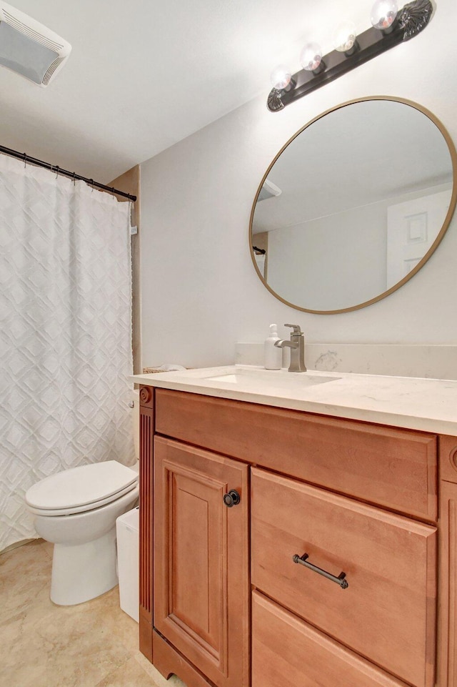 bathroom featuring toilet, vanity, and a shower with curtain