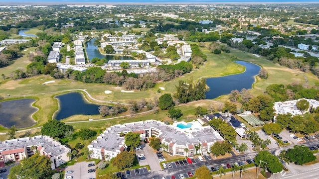 aerial view with a water view and view of golf course