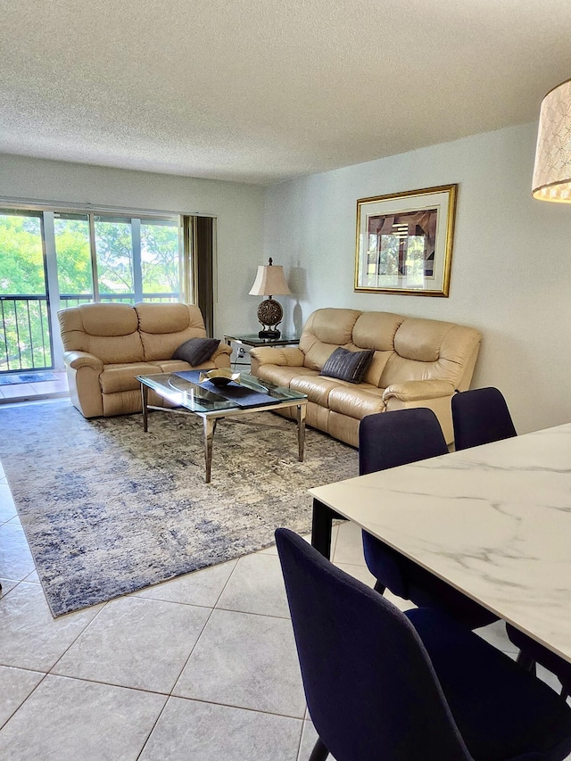 7185 Huntington Ln Unit 405, Delray Beach, FL 33446 - tiled living room featuring a textured ceiling