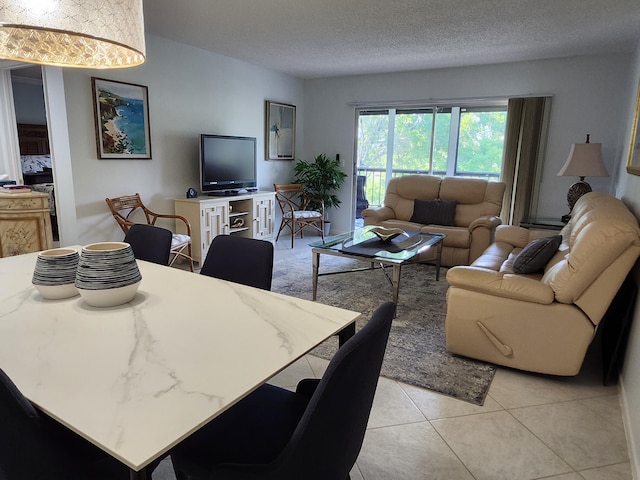 7185 Huntington Ln Unit 405, Delray Beach, FL 33446 - living room with light tile patterned floors and a textured ceiling