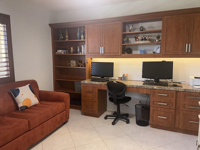 office space featuring light tile patterned floors and built in desk