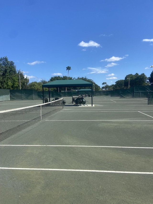 view of tennis court with fence