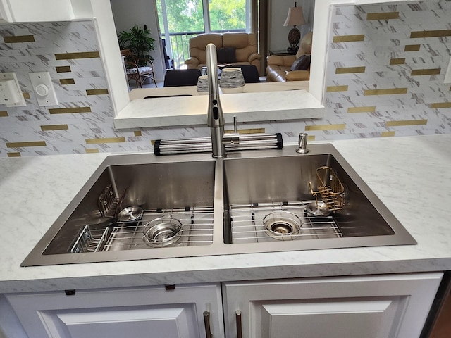 7185 Huntington Ln Unit 405, Delray Beach, FL 33446 - kitchen view of backsplash, a sink, and light countertops
