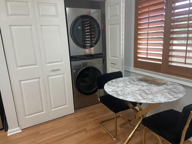 7185 Huntington Ln Unit 405, Delray Beach, FL 33446 - laundry area with stacked washer / dryer and light wood-style floors