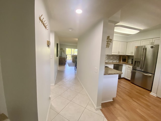 7185 Huntington Ln Unit 405, Delray Beach, FL 33446 - kitchen with stainless steel appliances, white cabinetry, tasteful backsplash, baseboards, and recessed lighting