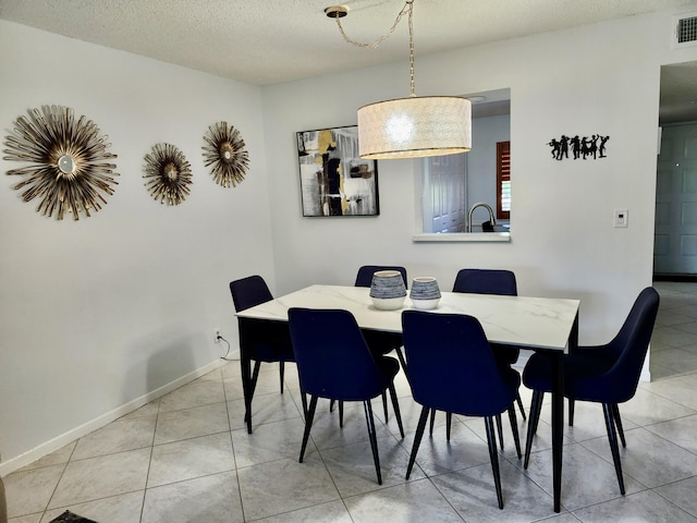 7185 Huntington Ln Unit 405, Delray Beach, FL 33446 - dining space with light tile patterned floors, a textured ceiling, and baseboards