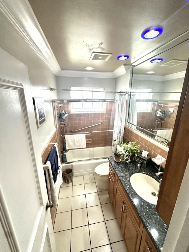 bathroom with plenty of natural light, visible vents, shower / bath combination with glass door, and ornamental molding