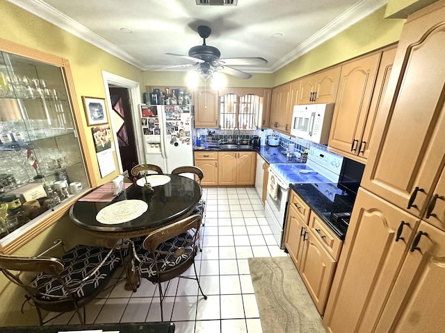 kitchen featuring visible vents, dark countertops, white appliances, light tile patterned flooring, and crown molding