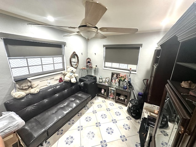 interior space featuring crown molding, a ceiling fan, and a textured wall