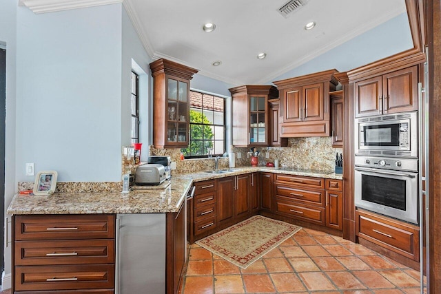2161 NW 59th St, Boca Raton, FL 33496 - kitchen with visible vents, ornamental molding, stainless steel appliances, vaulted ceiling, and tasteful backsplash