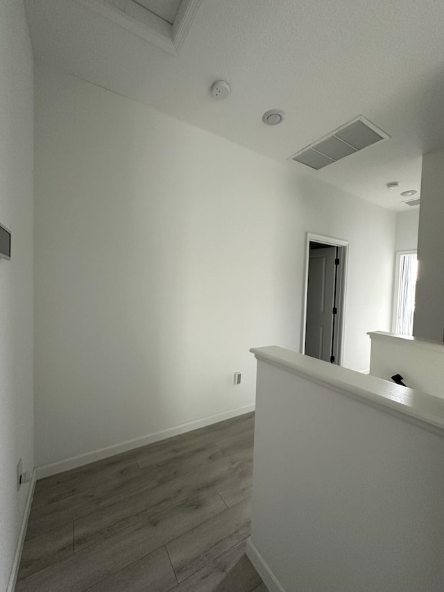 empty room featuring visible vents, baseboards, and dark wood finished floors