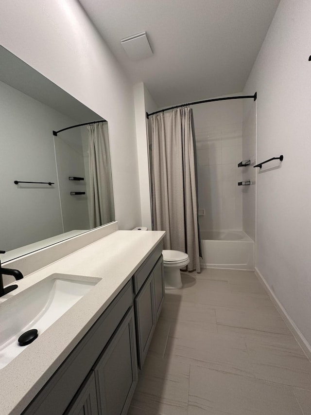 bathroom featuring baseboards, shower / tub combo, toilet, and vanity