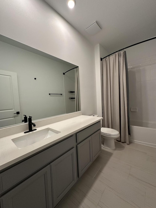 full bath featuring vanity, toilet, and shower / bathtub combination with curtain