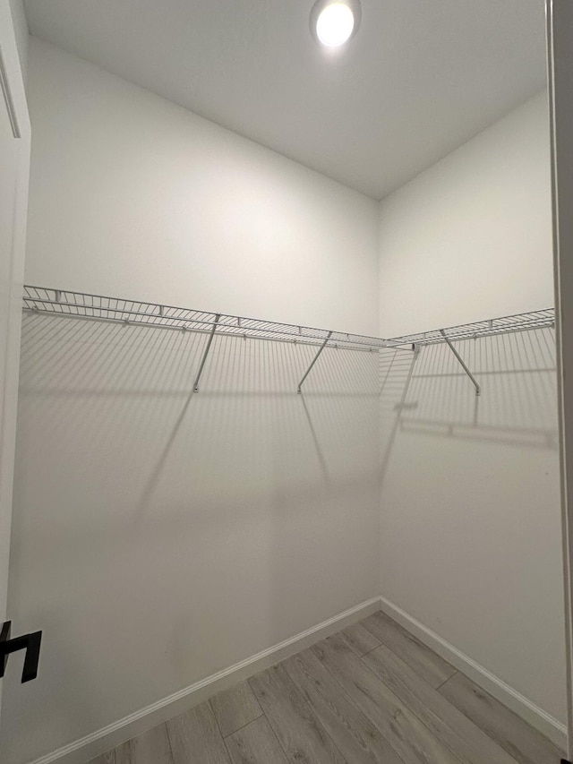 spacious closet with wood finished floors