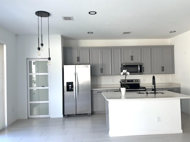 kitchen featuring gray cabinets, a sink, and appliances with stainless steel finishes