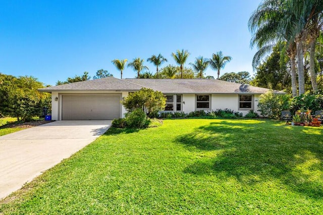 single story home featuring stucco siding, driveway, an attached garage, and a front yard