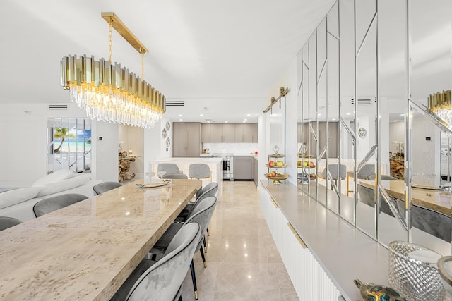 dining area featuring an inviting chandelier and light tile patterned flooring