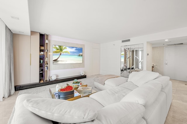 living room with light tile patterned flooring and visible vents