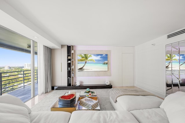 living area with a healthy amount of sunlight and a decorative wall