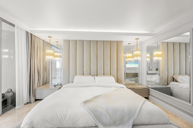 bedroom featuring multiple windows and a notable chandelier