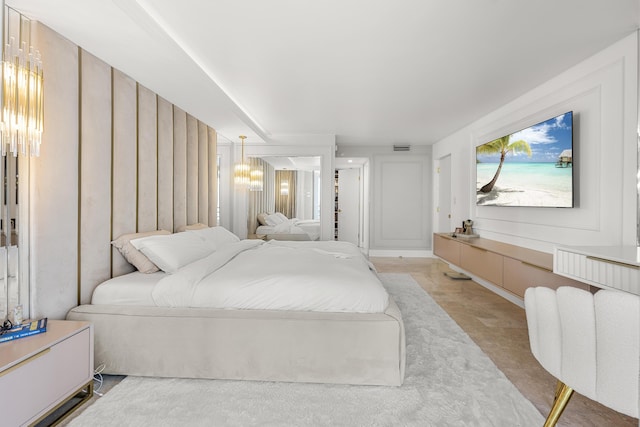 bedroom featuring an inviting chandelier and visible vents