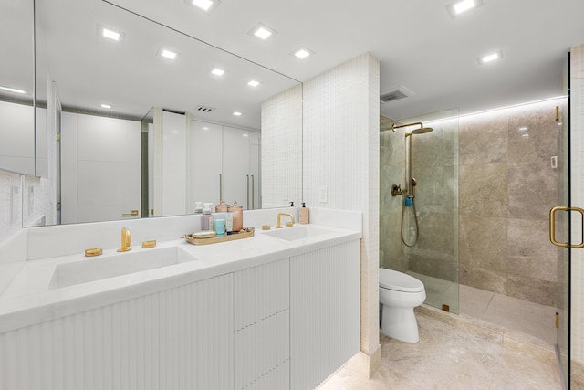 bathroom with visible vents, a shower stall, toilet, and a sink