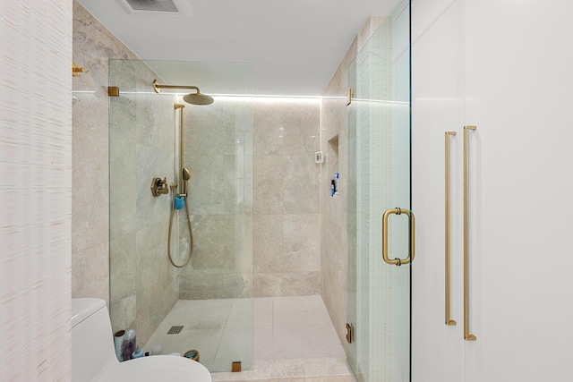 full bath featuring a shower stall, toilet, and visible vents