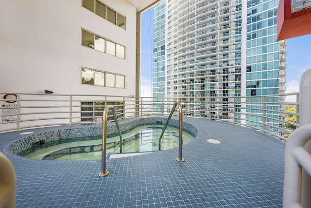 view of swimming pool with an indoor in ground hot tub