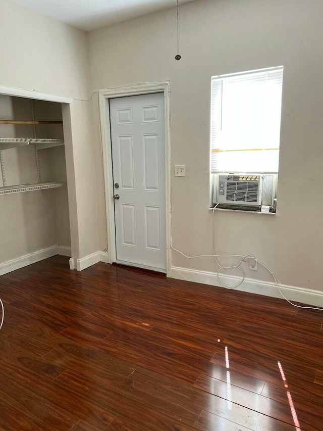 entrance foyer with baseboards, wood-type flooring, and cooling unit