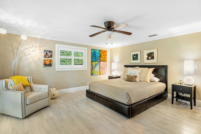 bedroom featuring visible vents, ceiling fan, baseboards, ornamental molding, and wood finished floors