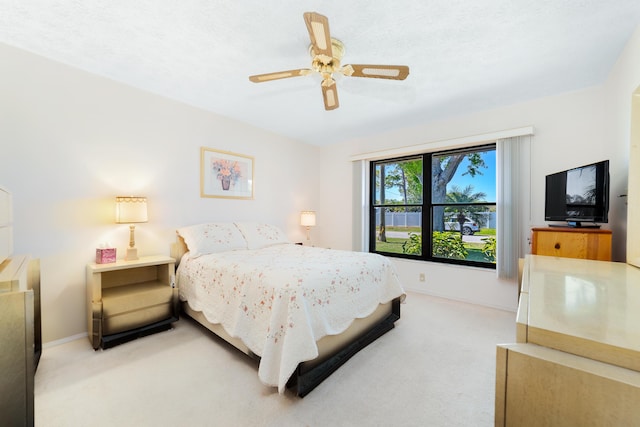 carpeted bedroom featuring ceiling fan and baseboards