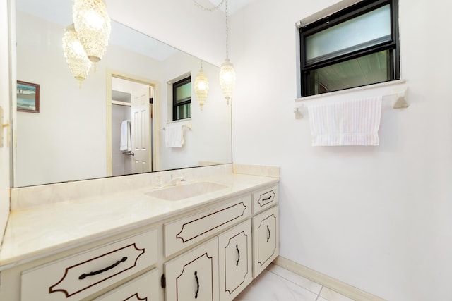 bathroom featuring baseboards, marble finish floor, and vanity