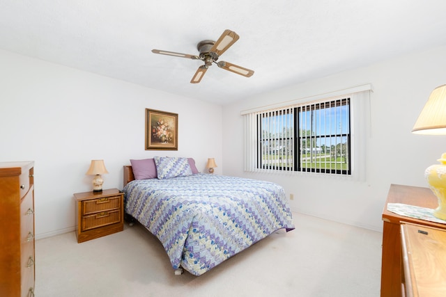 bedroom with baseboards, light carpet, and ceiling fan