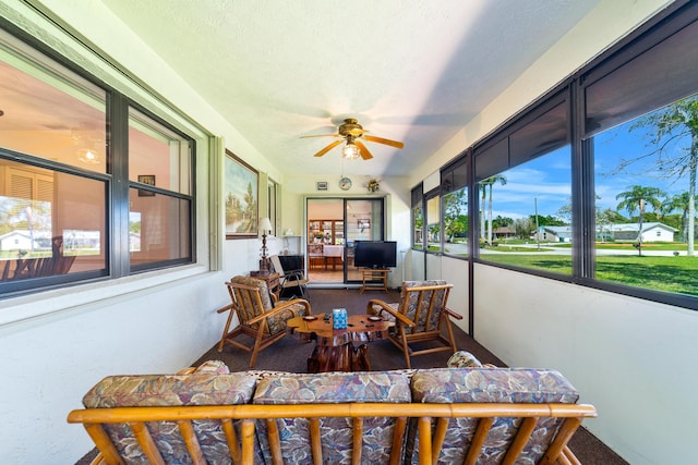 sunroom / solarium with a ceiling fan