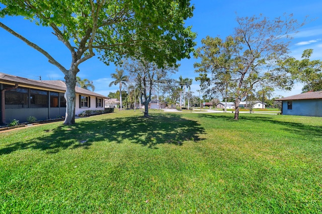 view of yard with a sunroom