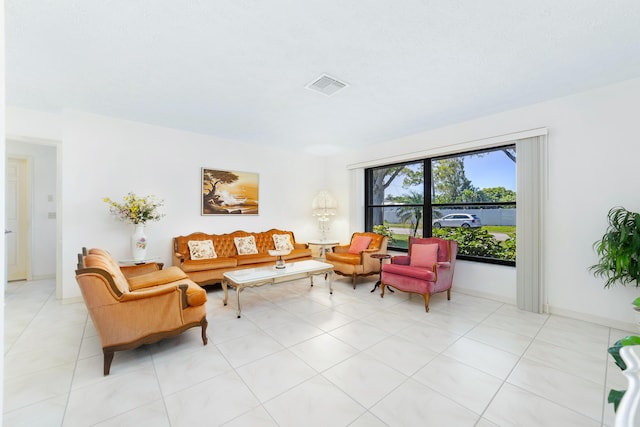 living room with light tile patterned flooring and visible vents