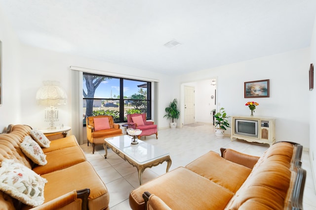 living room with light tile patterned floors and visible vents